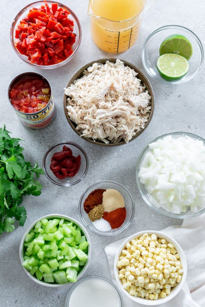 shredded chicken, peppers, celery, onion, and spices in small bowls