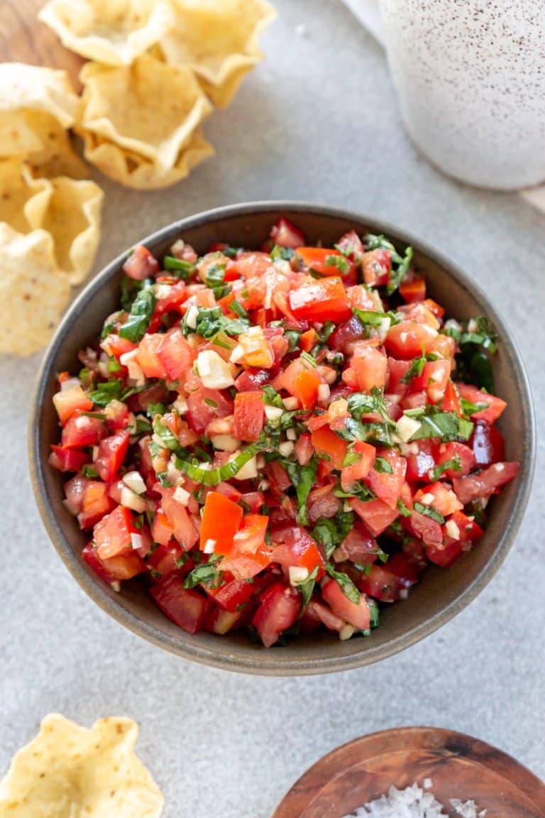 trader joe's bruschetta sauce in a bowl with chips on the side