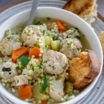 chickarina soup in a white bowl with toasted bread to the side