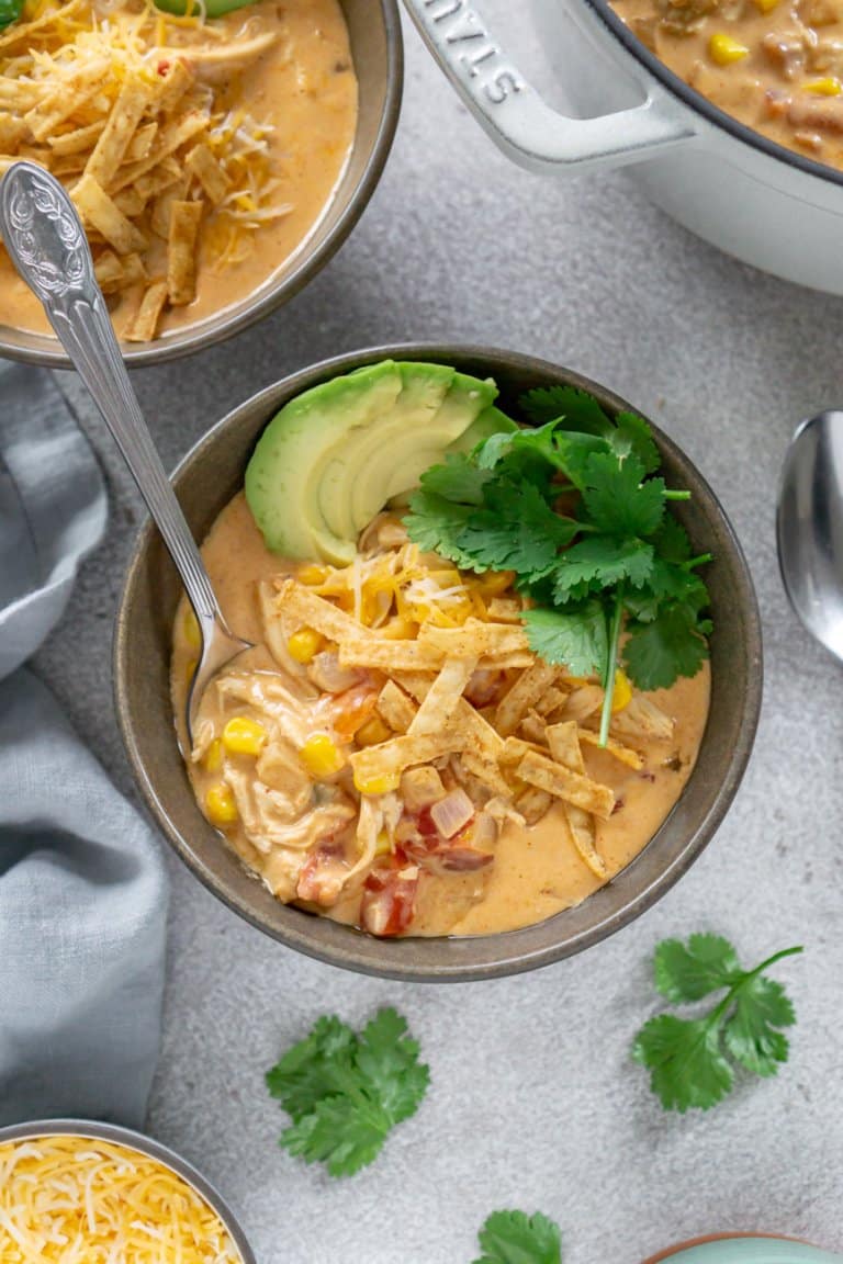 chicken taco soup in a bowl with a spoon, another bowl of soup to the side