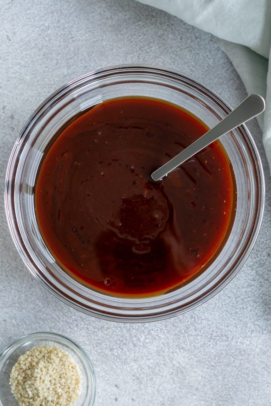 Honey hoisin sauce in a glass bowl.