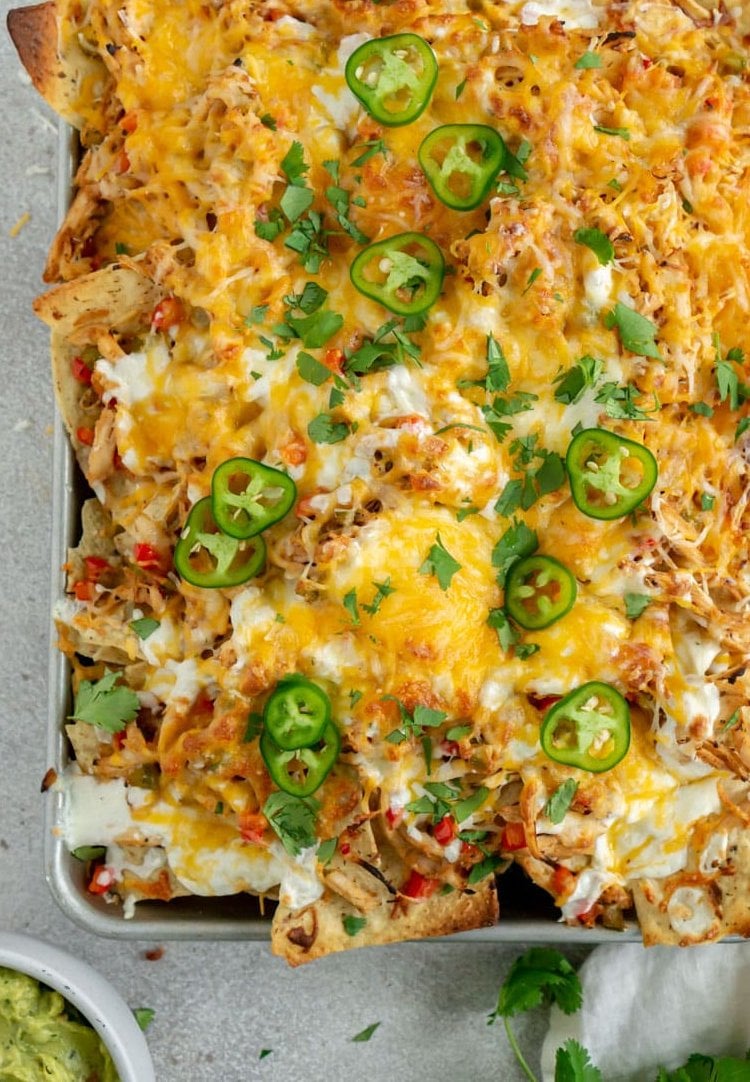 close up of chicken fajita nachos cooked on a sheet pan.