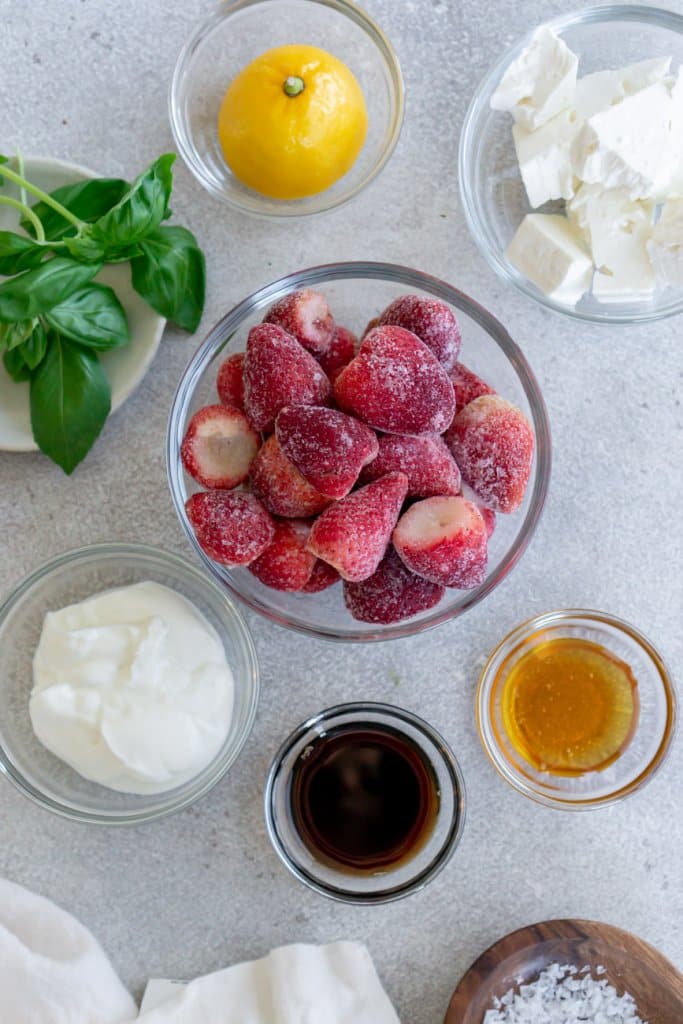 strawberries, lemon, basil, honey, balsamic vinegar, feta cheese in small ingredient bowls