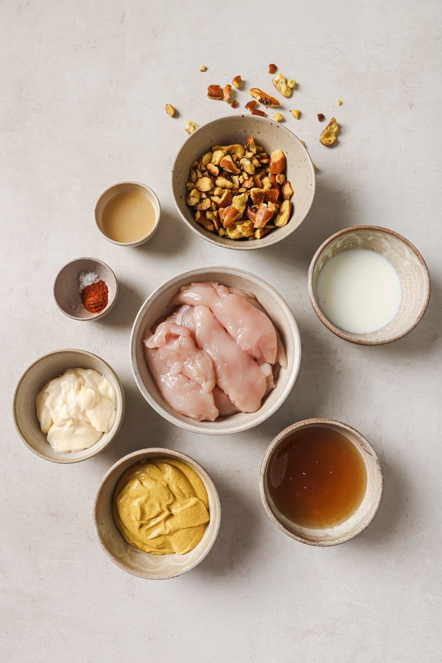 chicken tenders, honey mustard pretzel bites, honey mustard, buttermilk, honey, mayonnaise, and spices in small ingredient bowls.