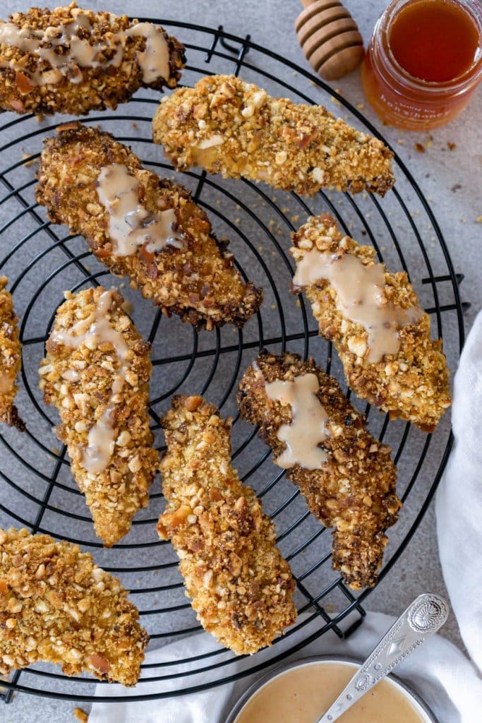 pretzel crusted chicken tenders on a wire cooling rack