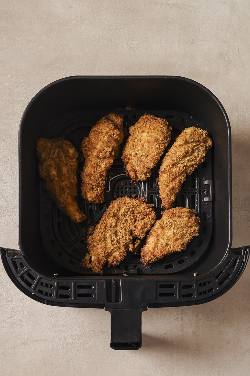 pretzel chicken in the air fryer basket.