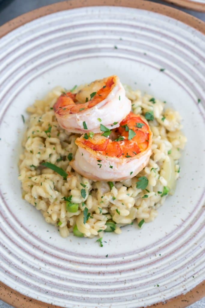 shrimp asparagus risotto in a white bowl