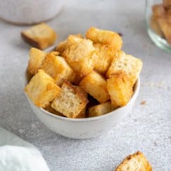 air fryer croutons in a small bowl with a green linen to the side