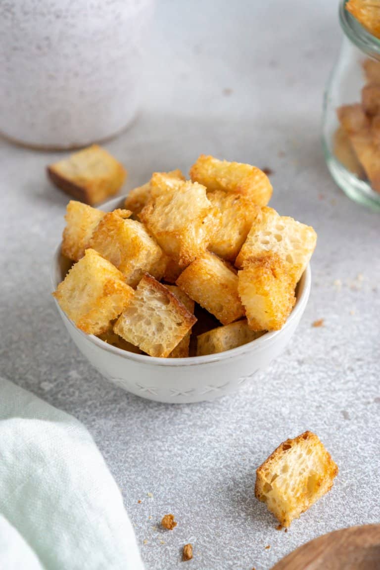 air fryer croutons in a small bowl with a green linen to the side