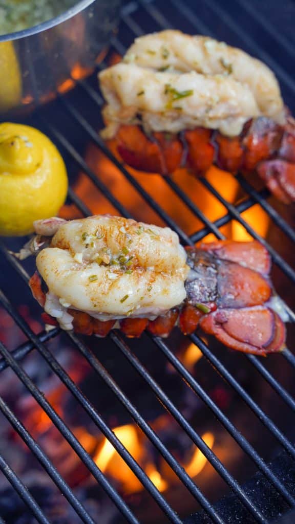 close up of lobster tail on frill with lemon in background