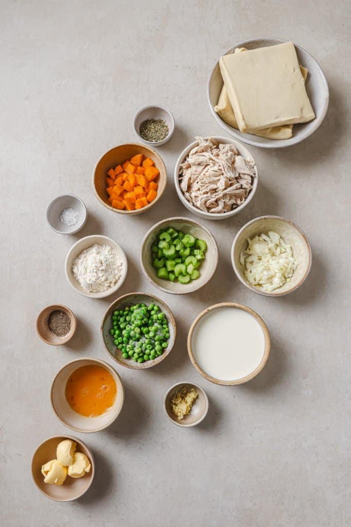 carrots, turkey, cream, onion, peas, and garlic in small ingredient bowls