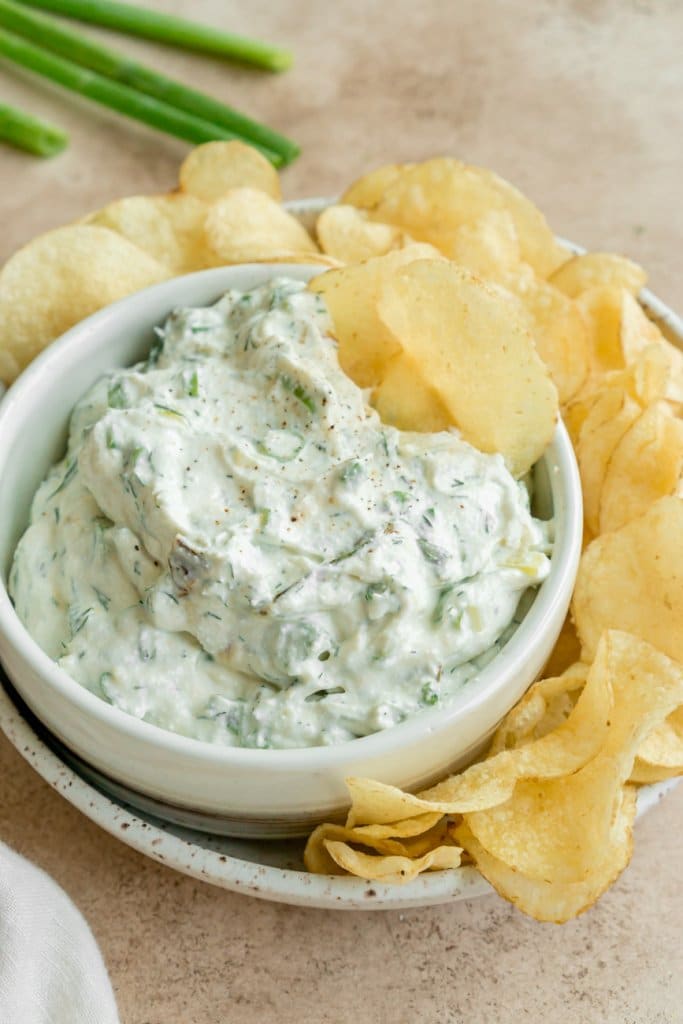 cottage cheese dip in a white bowl with potato chips around