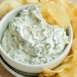 whipped cottage cheese dip in a white bowl with potato chips.