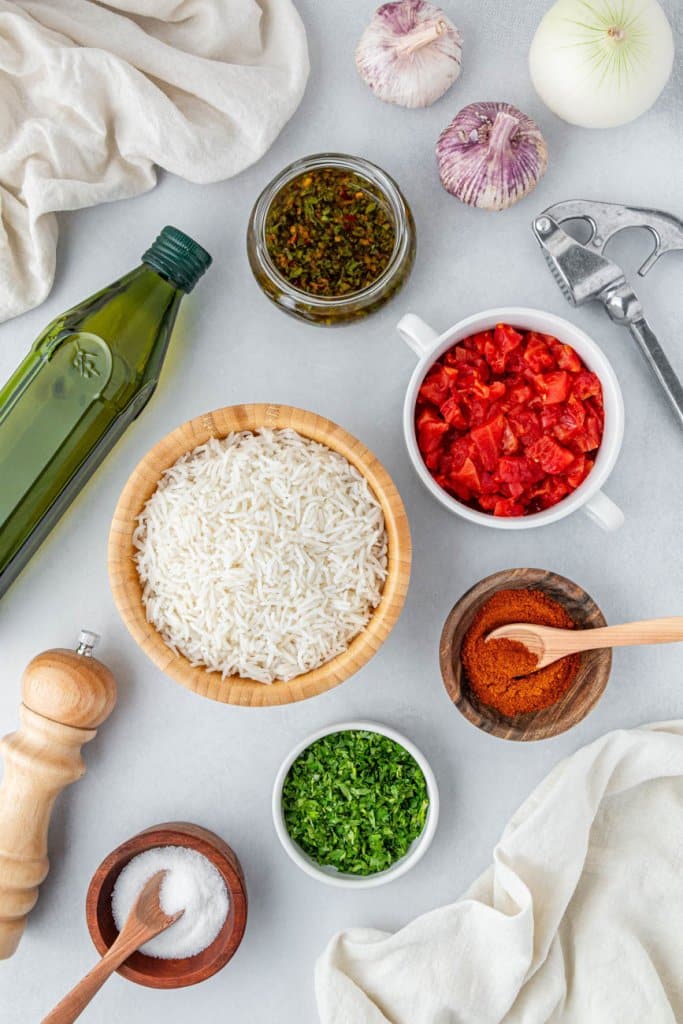 rice, diced tomatoes, spices, and chimichurri sauce in small ingredient bowls