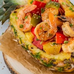 chinese pineapple shrimp with peppers in a pineapple boat