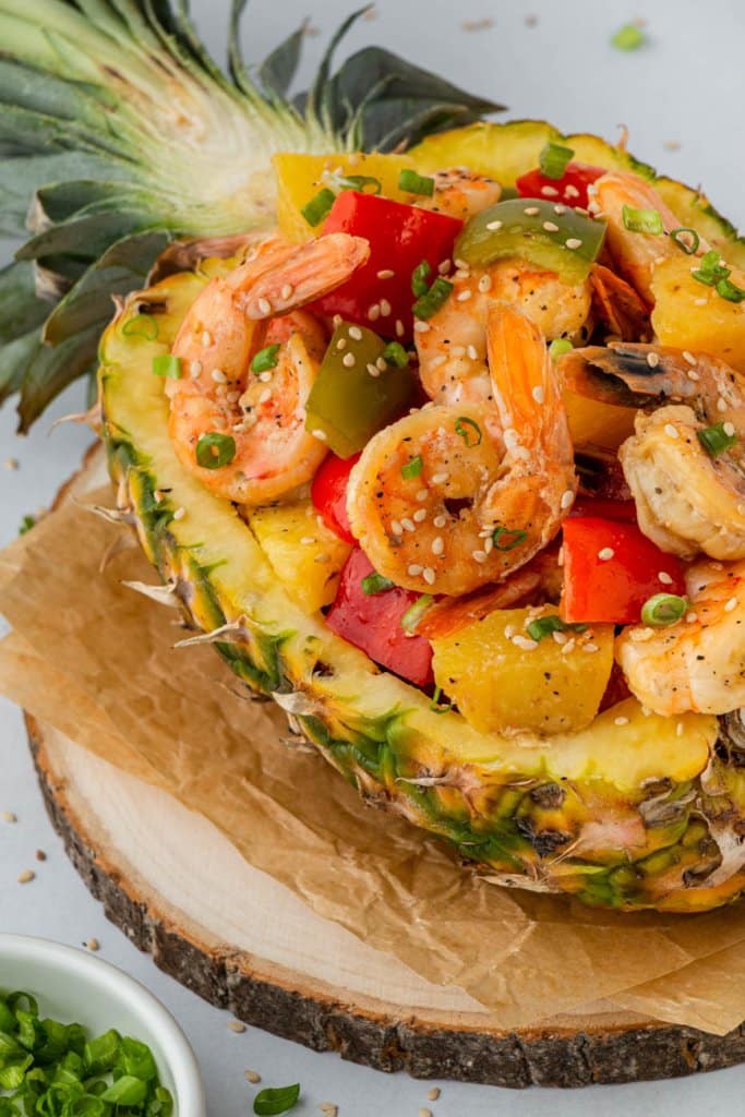 chinese pineapple shrimp with peppers in a pineapple boat