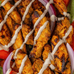 air fryer chicken shawarma with sauce drizzles over top