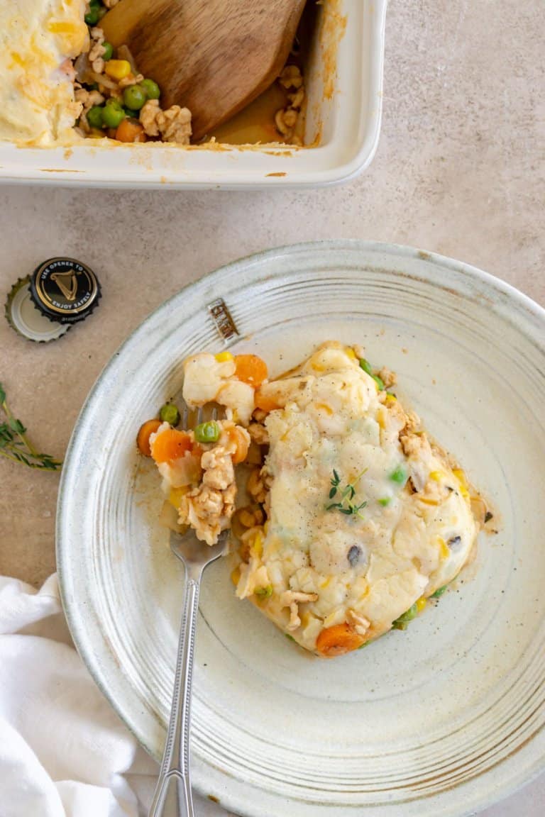 a piece of ground turkey shepherd's pie on a plate with a fork