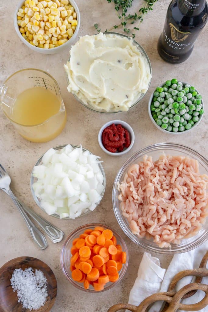 ground turkey, guinness beer, peas, onions, mashed potatoes, carrots, and corn in small ingredient bowls