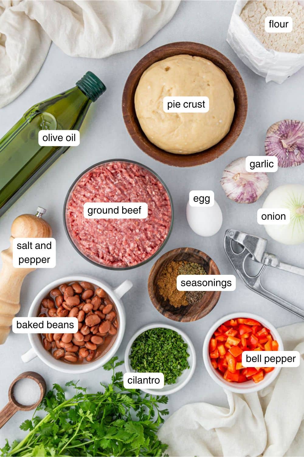 Ingredients needed to make Air Fryer Beef Empanadas portioned out into ingredient bowls.