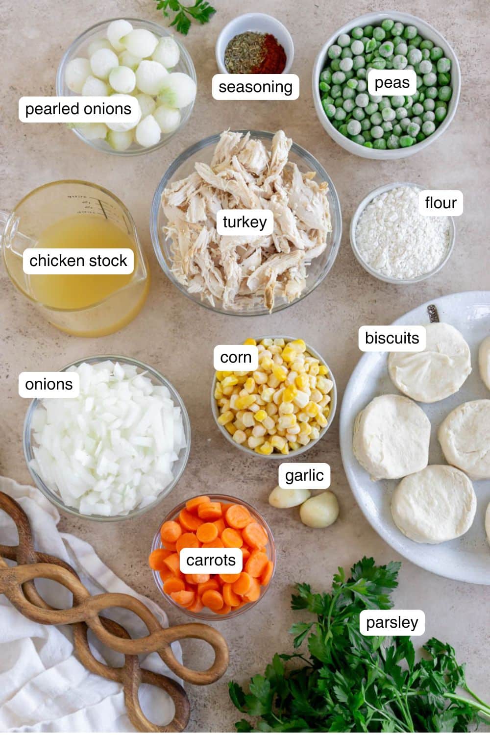 Ingredients needed to make Turkey Pot Pie With Biscuits, portioned out on top of a counter.