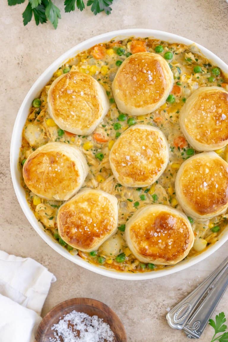 turkey pot pie with biscuits in a pie dish with salt and a napkin on the side