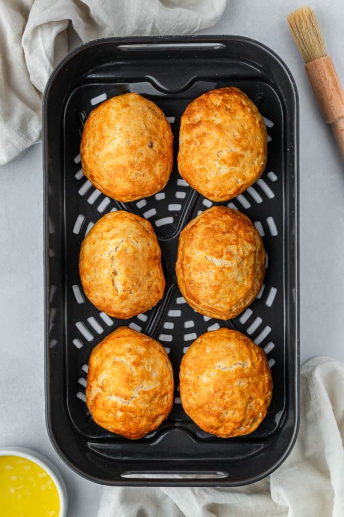 cooked biscuits in an air fryer basket