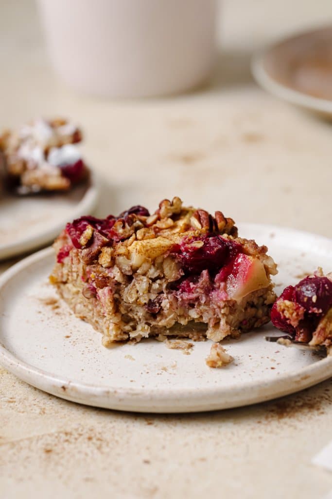 cranberry baked oatmeal square on a white plate