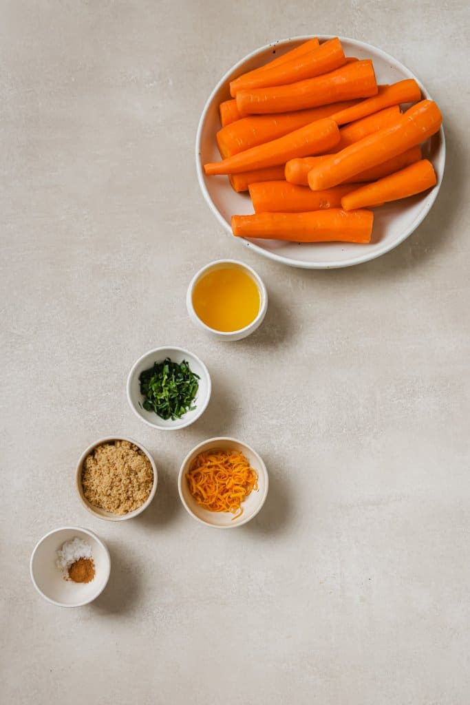 carrots, honey, herbs, brown sugar, and salt in small ingredient bowls