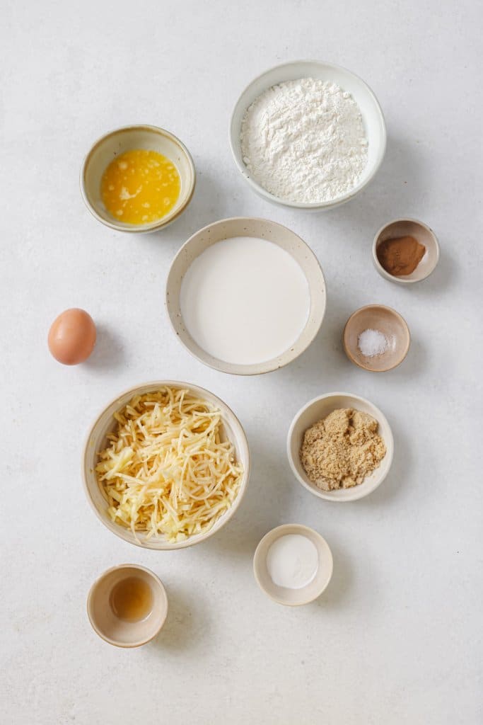 flour, apples, egg, brown sugar, and milk in small ingredient bowls