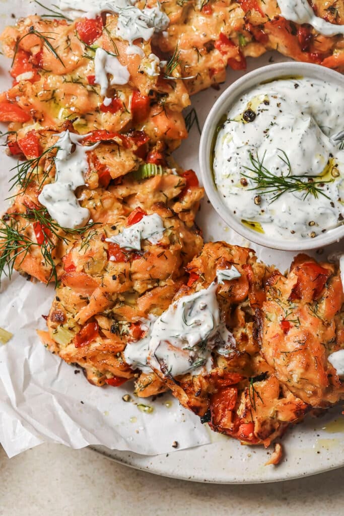 oven baked salmon patties on a plate with lemon dill sauce