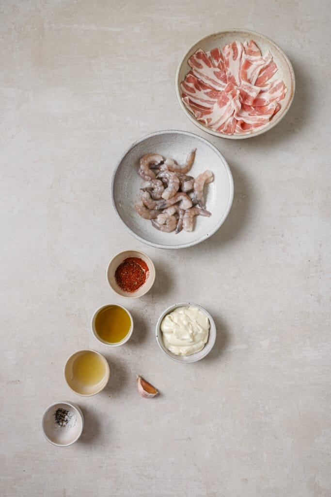 shrimp, bacon, garlic aioli, garlic, and spices in small ingredient bowls