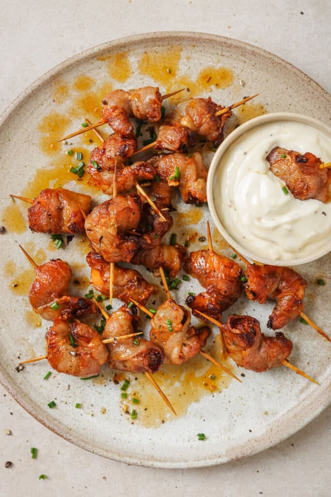 air fryer bacon wrapped shrimp on a plate with garlic aioli