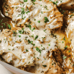 french onion chicken in a pan with parsley on top