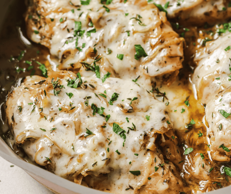 french onion chicken in a pan with parsley on top