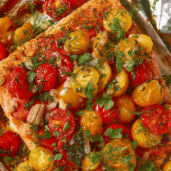 Close up view of foil baked salmon with cherry tomatoes.