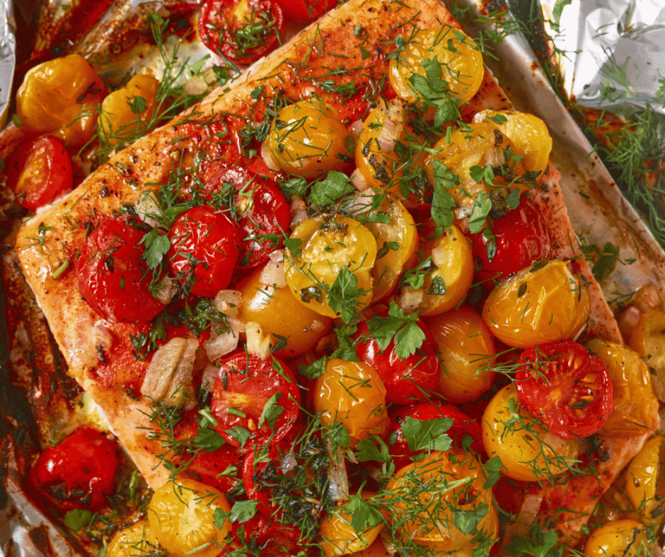 Close up view of foil baked salmon with cherry tomatoes.