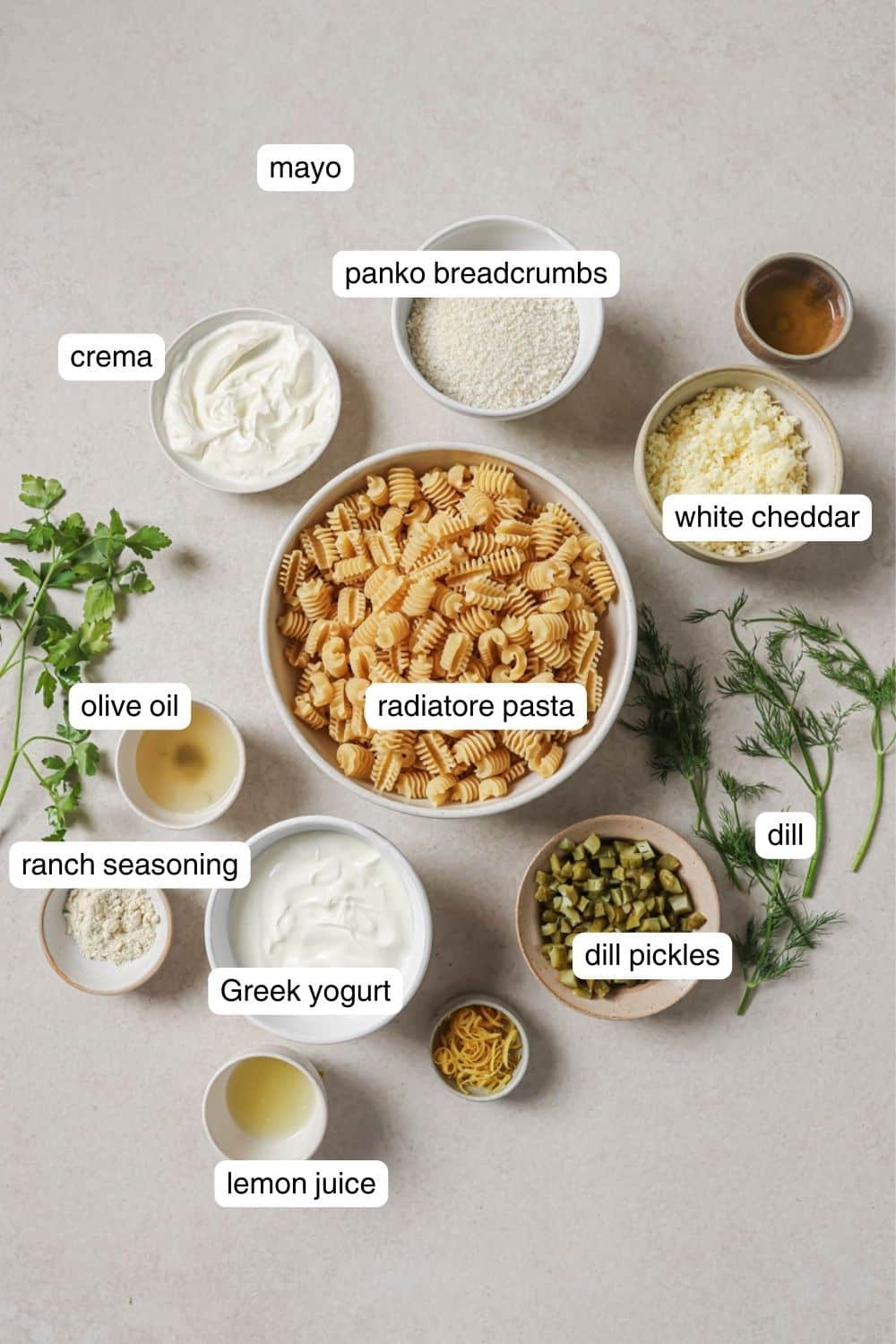 pasta, cotija cheese, pickles, dill, and greek yogurt in small ingredient bowls