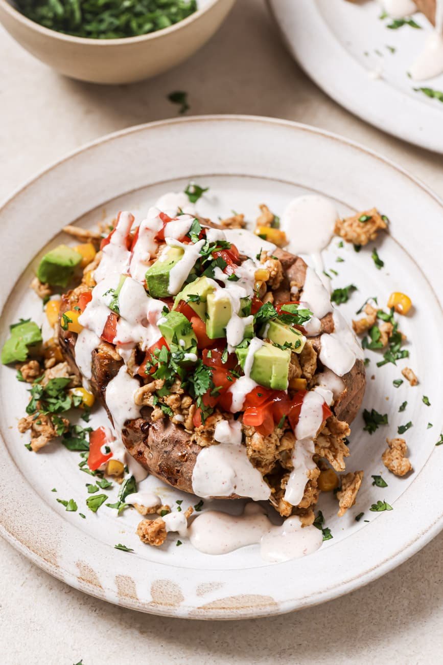 A plate of taco sweet potatoes with lime crema.