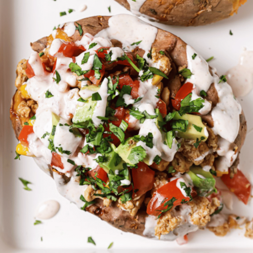 taco stuffed sweet potatoes on a white baking sheet