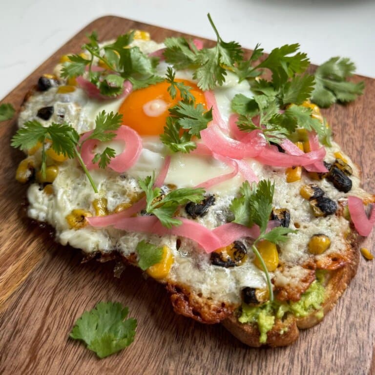 viral feta eggs on avocado toast with pickled onions and cilantro