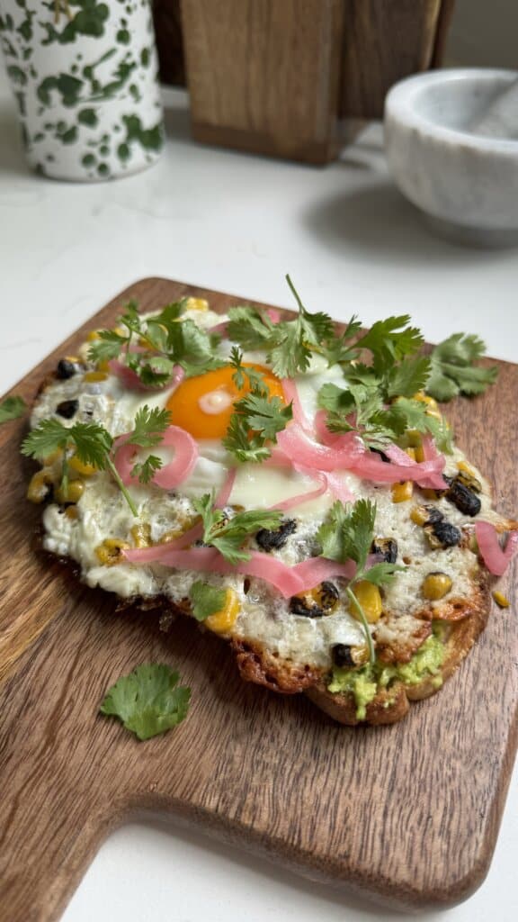 viral feta eggs on avocado toast with pickled onions and cilantro