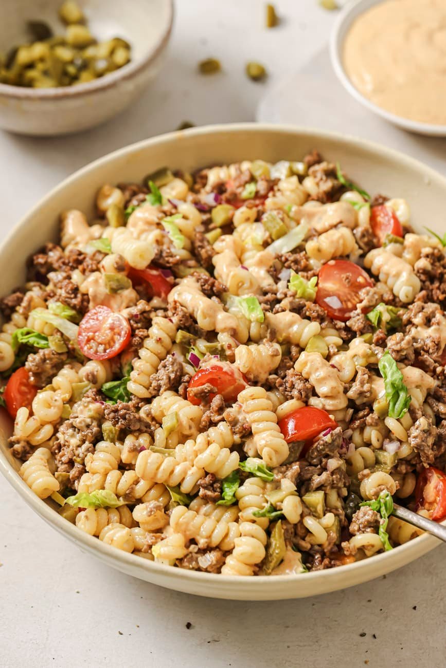 A bowl of cheeseburger pasta salad with meat.