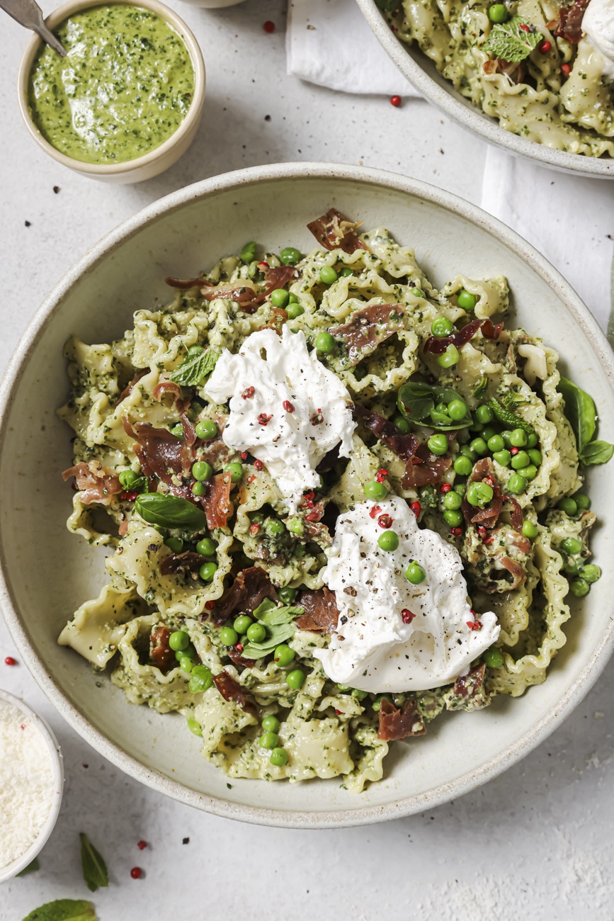 Overhead shot of a bowl of pesto prosciutto pasta.