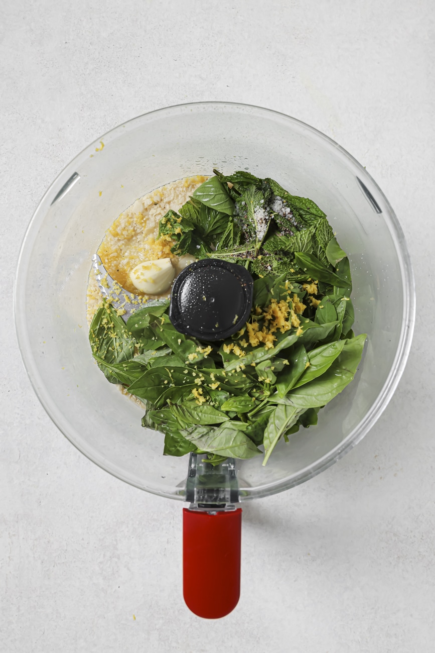 Ingredients for pesto in a food processor.