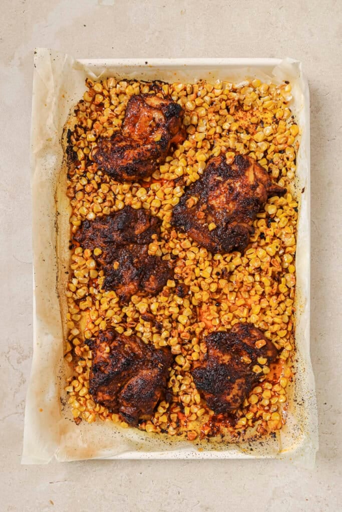 Corn and chicken on a sheet pan.