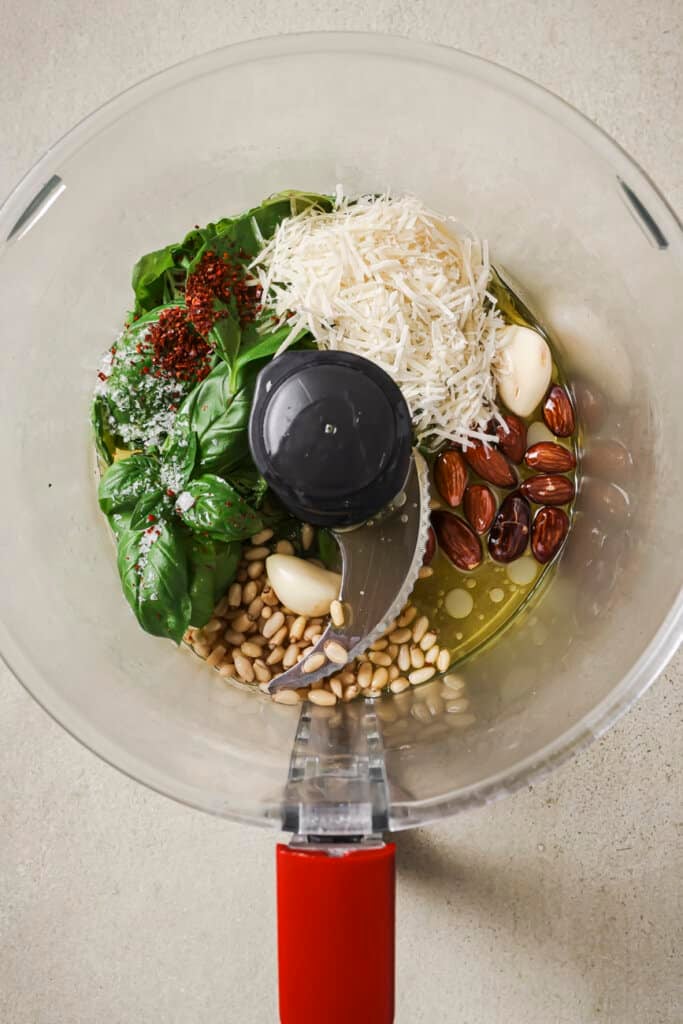 Pesto ingredients in a food processor.