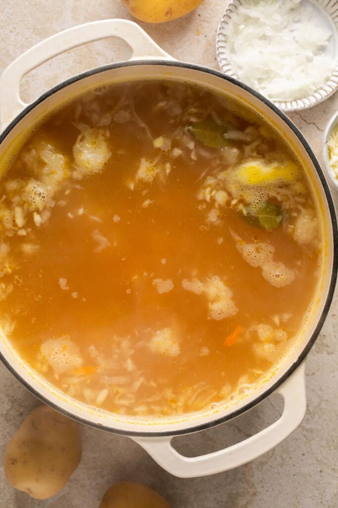 Dill pickle soup cooking in a pot.