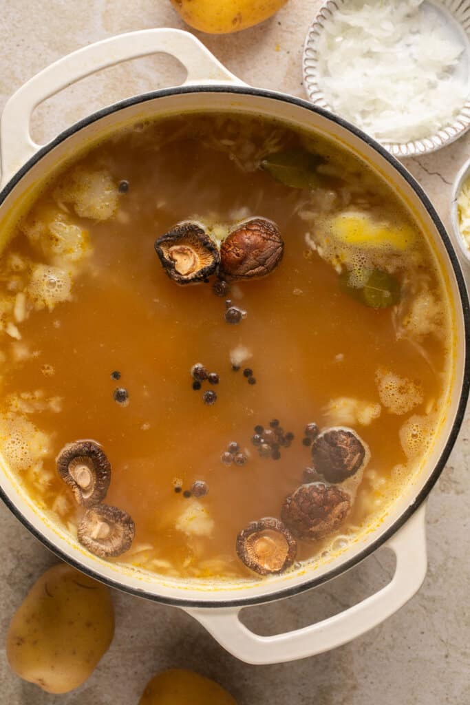 Dried mushrooms floating in pickle soup broth.