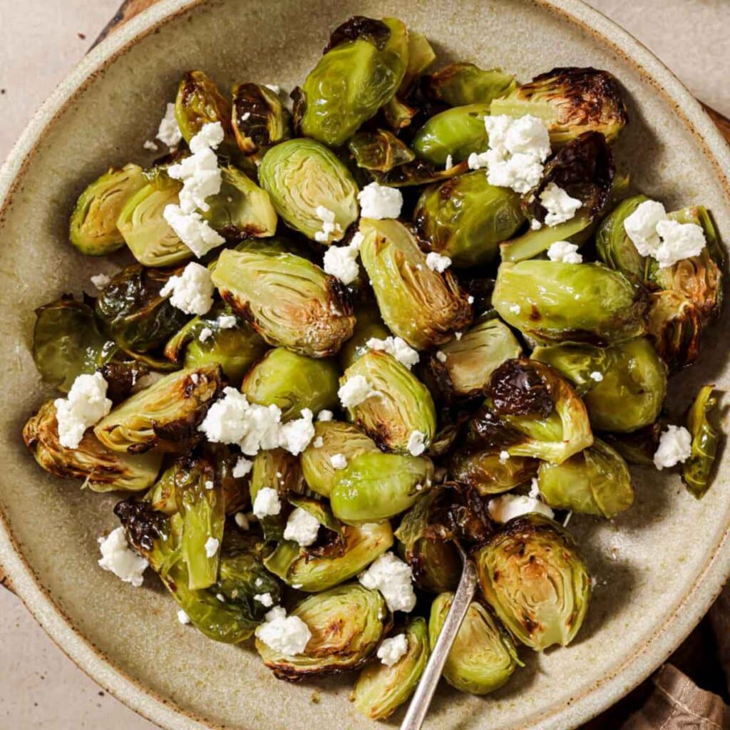 Close up top-down view of air fryer brussels sprouts on a plate.